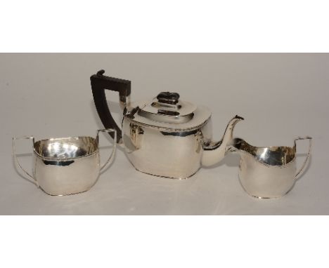 A silver teaset, hallmarks for Birmingham 1921/1924 SB&S, comprising of teapot, milk and sugar, of plain design with gadroone