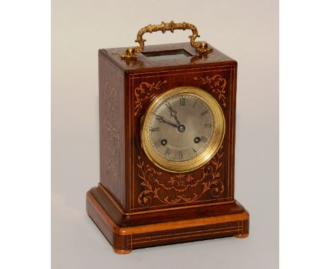 A 19th century French Rosewood inlaid mantel clock, with foliate designs and ormolu handle, silvered dial, the movement strik