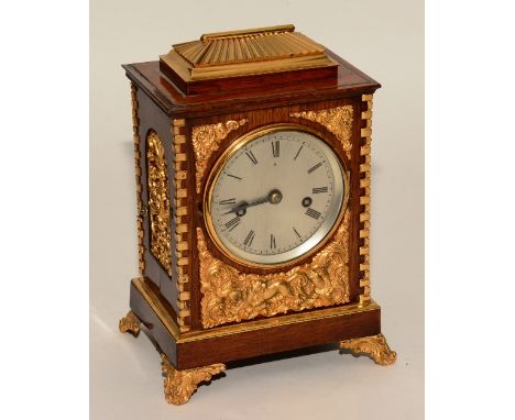 A 19th century rosewood gilt metal and ormolu mantel clock, the silvered dial with Roman numerals, decorated with gilt metal 