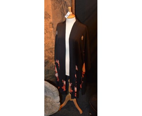 A vintage Japanese black and orange silk kimono, the black exterior decorated with orange and gold foliage, the orange interi