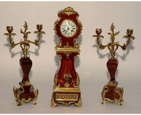 A French Louis XVI style red tortoiseshell and gilt metal clock garniture, in the the form of a longcase clock circa 1900, th