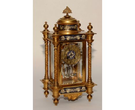 A French Louis XVI style gilt metal ormolu and champleve enamel decorated four glass mantel clock, the gilt and enamel dial s