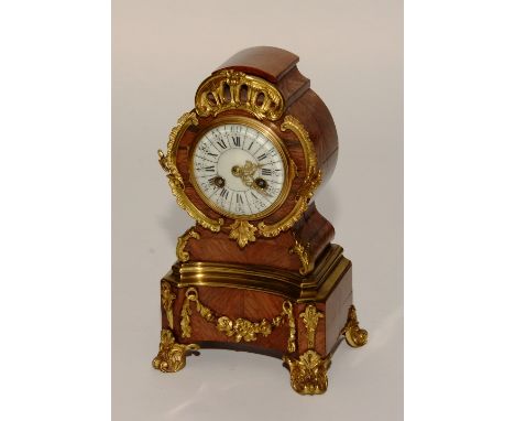 A 19th century French Louis XVI style kingwood and gilt metal mantel clock, the white enamel dial set with Roman and Arabic n