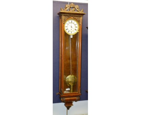 A Continental weight driven regulator wall clock, the 6½" cream enamel dial with Roman numerals and ormolu border, above glaz