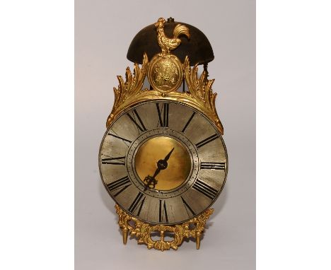 A French brass lantern clock circa 17th century, with bell and gilt metal cockerel surmount to the top, crested motif below o