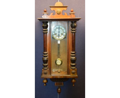 An early 20th century mahogany cased Vienna wall clock, with glazed door enclosing white enamel dial with Roman numerals, 99c