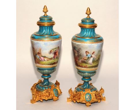 A pair of good quality French enamel and ormolu urns with covers, of baluster form, with pineapple finial to the top above Co
