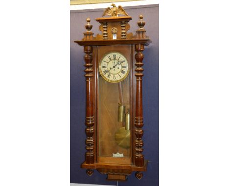 An early 20th century walnut cased Vienna wall clock signed by Gustav Becker, with eagle surmount to the top, flanked by a tu