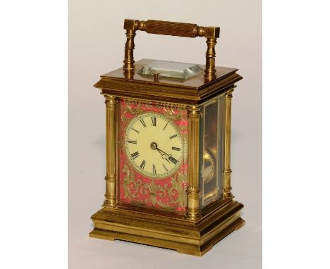 A French brass repeater carriage clock circa 1900, the cream enamel dial with Roman numerals, pierced brass decoration to the