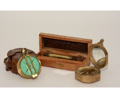 A brass pocket compass by Elliot Bros of London, 7cm diameter, in fitted leather case, also with another brass pocket compass