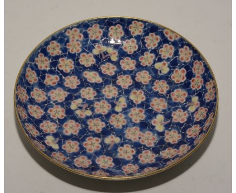 A Chinese circular plate, decorated with red and yellow flowers on blue ground, four character marks to base, 20cm diameter C