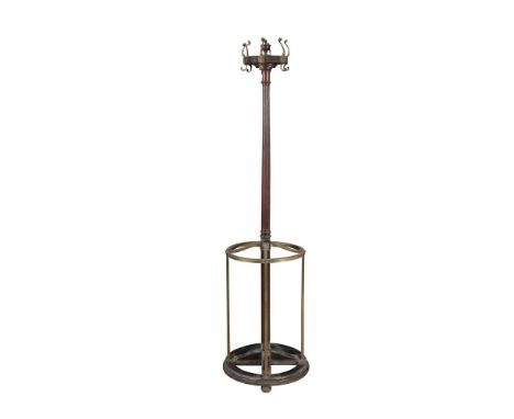 A VICTORIAN BRASS AND MAHOGANY CIRCULAR COAT AND STICK STAND, with fluted column and brass surrounding base. 180cm tall