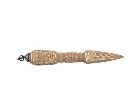 A TIBETAN CARVED BONE PHURBA DAGGER, 19th Century, surmounted with silvered dorje finial, and handle carved with three masks 