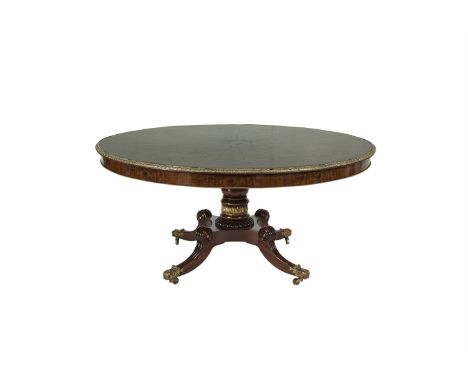 A FRENCH EARLY 19TH CENTURY BURR WALNUT AND MAHOGANY CIRCULAR DINING TABLE, the top centred with a star burst and radial vene