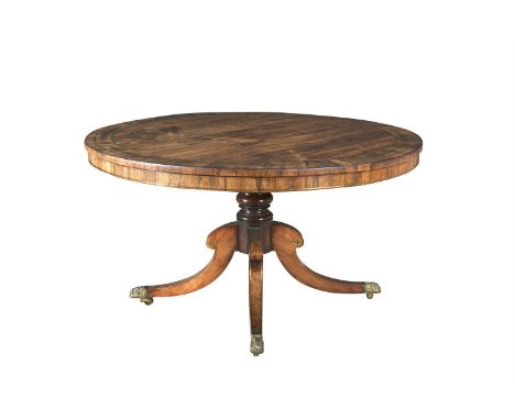 A GEORGE IV INLAID ROSEWOOD CIRCULAR BREAKFAST TABLE, decorated with brass stringing and scrolls, raised on turned centre pil