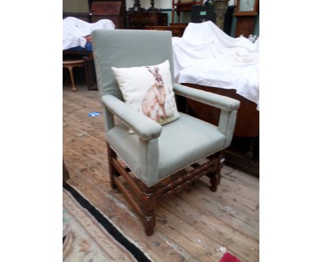 Oak framed armchair, the padded backs, arms and seat upholstered in light blue contemporary cloth