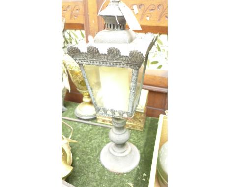 Ornate metal framed lamp holder on circular plinth
