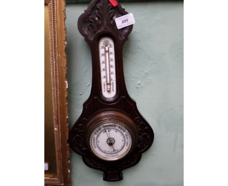 Aneroid wall barometer in carved oak case with thermometer dial