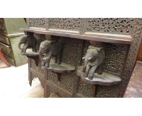 Most decorative Asian hanging wall display carved unit in black wood, the open display shelf supported by 3 carved elephants 