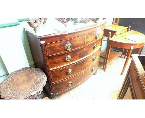 Figured mahogany bow fronted chest of two short and three graduated drawers each with brass garland finger plates and circula