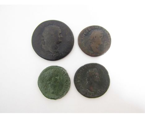 Four Roman bronze coins including Sestertius of Titus (79-81AD) two dupondis of Domitian (81-96AD) and of Nerva (96-98AD)