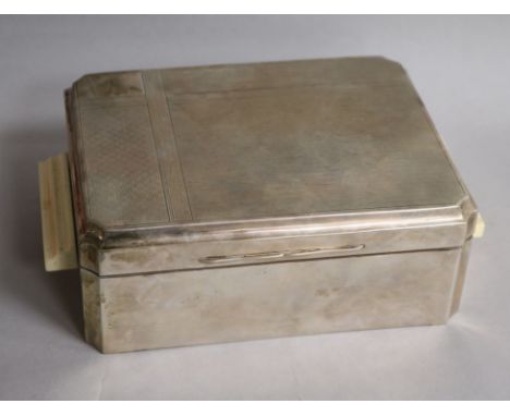 A George V Art Deco engine turned silver cigarette box, with ivory handles, James Dixon & Sons, Birmingham, 1934, 24.5cm incl