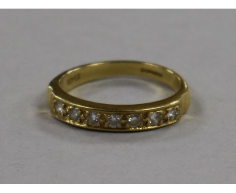 An 18ct gold and seven stone diamond half eternity ring, size R.