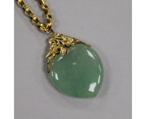 A yellow metal mounted heart shaped jade pendant, on a 9ct gold chain, pendant 39mm.