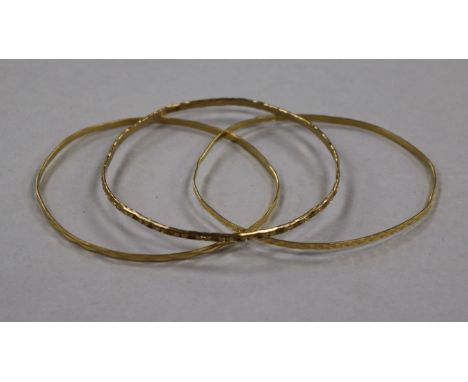 A 9ct gold bangle and two 18ct gold bangles, 15g