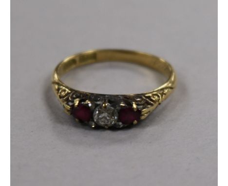 An early-mid 20th century 18ct gold ruby and diamond three stone ring, size P.