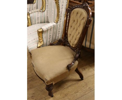 A Victorian walnut button back nursing chair