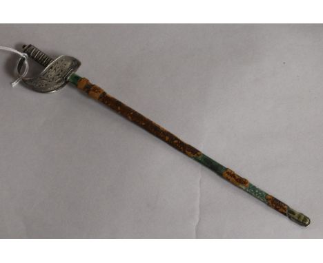 An early 20th century novelty sterling silver letter opener, modelled as a sabre in leather scabbard, 23cm.