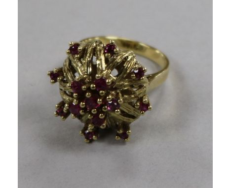 A 14ct gold and ruby set cocktail ring, size M.