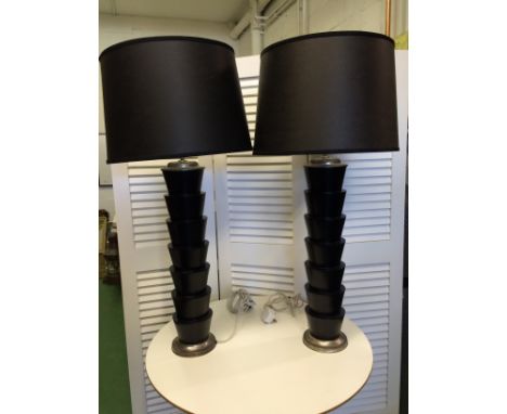 Pair of black stacked conical lamp bases with cylindrical shades