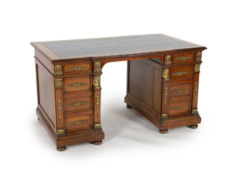 An early 20th century French classical revival mahogany breakfront pedestal desk, with dark green leather skiver and four gra