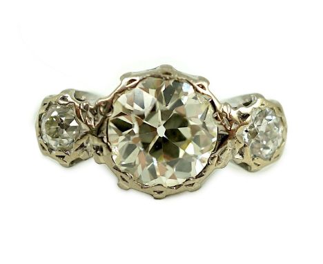 A white gold and collet set three stone diamond ring, the central stone weight approximately 2.08ct, the outer stones each ap