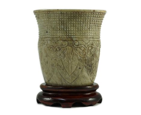 A Chinese archaistic burnt ‘chicken bone’ jade oval cup, chan, probably Song dynasty, carved in low relief with a chequered b