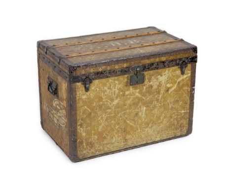 An early 20th century Louis Vuitton iron bound travelling trunk, with yellow LV fabric covering and old shipping labels, the 
