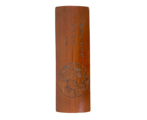 A Chinese inscribed bamboo arm or wrist rest, Kangxi period, carved in relief with a horse, pine and rock to a roundel and in