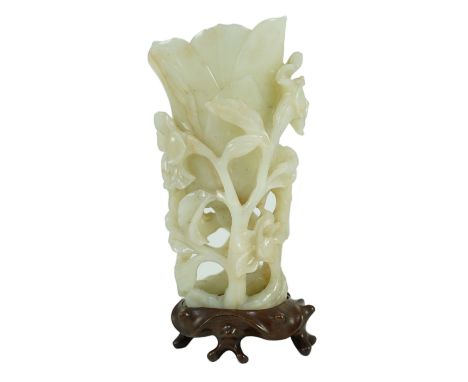 A large Chinese pale celadon jade ‘magnolia’ cup, 17th/18th century carved in high relief and openwork with branches in leave