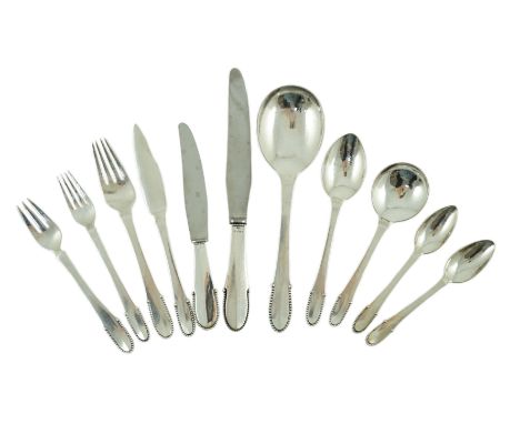 An early 20th century Georg Jensen canteen of beaded pattern silver cutlery, comprising six each of the following, soup spoon