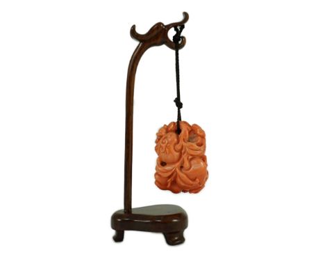 A good Chinese coral ‘fruit and bats’ pendant, 19th century, carved in high relief and open work with two bats amid peaches, 