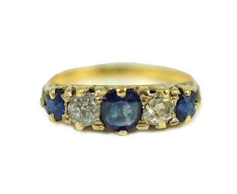 An 18ct gold, graduated three stone sapphire and two stone diamond set half hoop ring, with carved setting, size M, gross wei