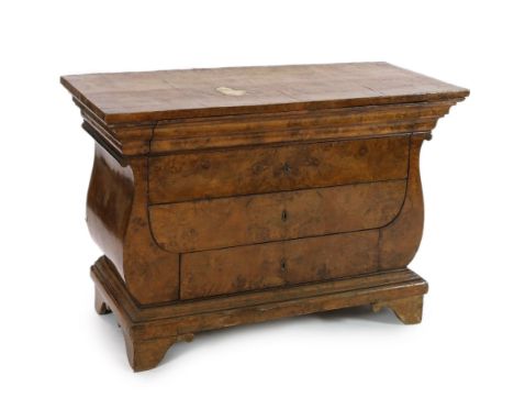 An early 19th century Baltic region burr wood commode, with rectangular top and lyre shaped sides, fitted four drawers on bra