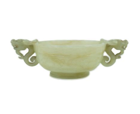 A Chinese pale celadon jade two handled ‘chilong’ cup, 17th/18th century, with a pair of carved dragon-head handles, and a ce