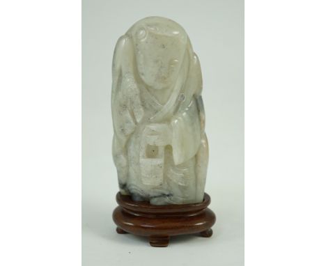 A Chinese white, grey and russet jade figure of Zhou Yanzi, Ming dynasty, the crouching figure holding a milk pail and wearin