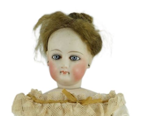 An S.G. bisque shoulder head French fashion doll c.1875, cork pate mohair wig attached, swivel neck, pale blue glass eyes, ki