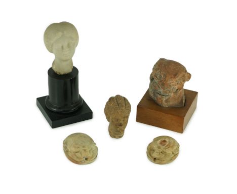 A group of antiquities comprising two commemorative scarabs, an Egyptian style gypsum head, and two antique terracotta headsS