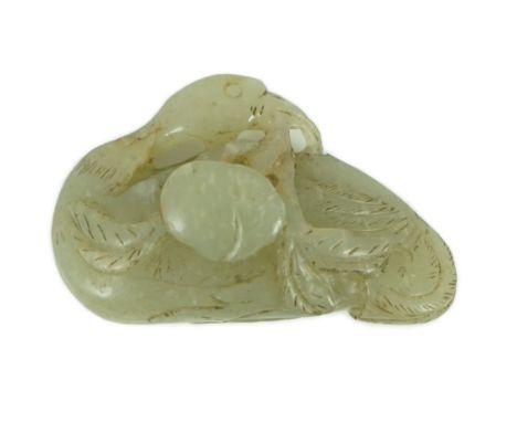 A Chinese pale celadon jade carving of a duck, possibly Jin-Yuan dynasty its head turned backward and grasping a peach sprig 