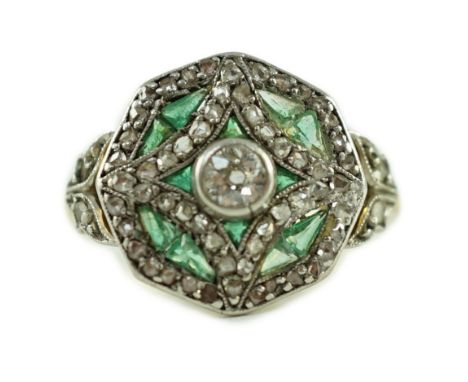 A Belle Epoque gold, emerald and diamond cluster set octagonal dress ring, size M, gross 4 grams.Two of the small emerald eac